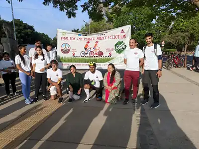 Group of cyclothon participants with Pedal for the Planet millet banner
