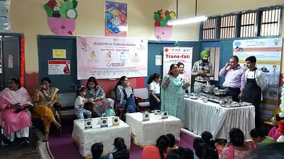 Cooking demonstration and audience at Poshan Maah event