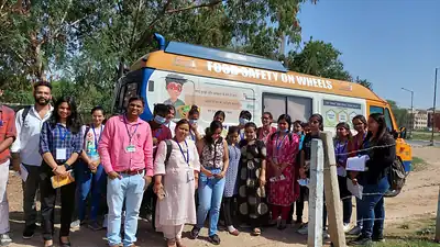 Participants gathered beside Food Safety on Wheels mobile lab van