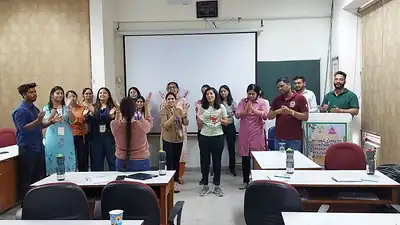 Workshop participants cheering in classroom, public health nutrition training