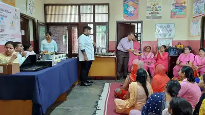 Nutrition demonstration to anganwadi workers in pink uniforms