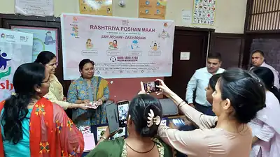 Participants photographing display at Rashtriya Poshan Maah event