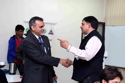 Two faculty members shaking hands at 2nd NWHSS 2016, PGIMER Chandigarh