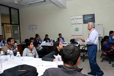 Faculty addressing participants seated at round tables in training room at 2nd NWHSS 2016, PGIMER Chandigarh