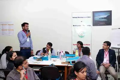 Participant speaking at group table with workshop banner behind at 2nd NWHSS 2016, PGIMER Chandigarh