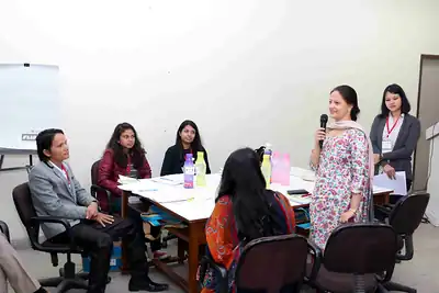 Woman standing to speak during group work among seated participants at 2nd NWHSS 2016, PGIMER Chandigarh