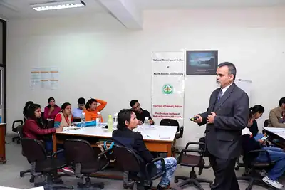 Faculty standing among participants at group tables during session at 2nd NWHSS 2016, PGIMER Chandigarh