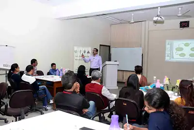 Classroom session with presentation projected and participants at tables at 2nd NWHSS 2016, PGIMER Chandigarh