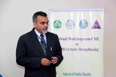 Speaker in suit in front of workshop banner at 2nd NWHSS 2016, PGIMER Chandigarh