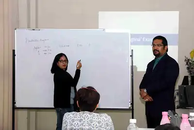 Participant writing on whiteboard while facilitator watches at 2nd NWHSS 2016, PGIMER Chandigarh
