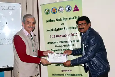 Presentation of a certificate or memento to a participant or speaker at NWHSS 2017, PGIMER Chandigarh