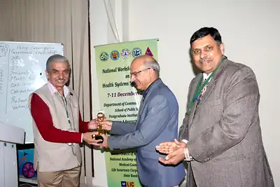 Presentation of a certificate or memento to a participant or speaker at NWHSS 2017, PGIMER Chandigarh