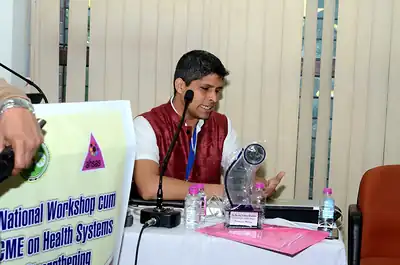 Speaker seated at the dais with a memento, 4th NWHSS, PGIMER Dec 2018