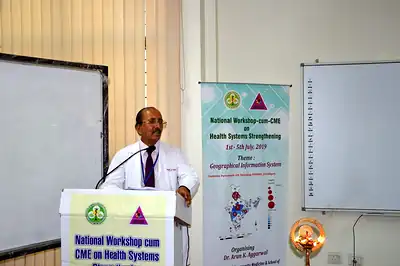 Speaker at podium beside the GIS workshop banner, 5th NWHSS GIS for public health, PGIMER 2019