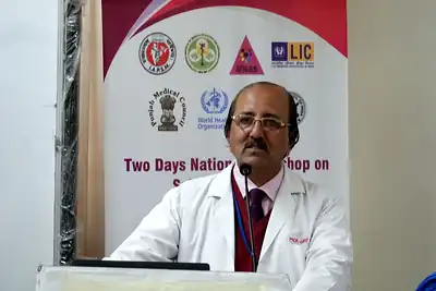Speaker in a white coat at the podium, 6th NWHSS with Scientific Writing workshop, PGIMER Dec 2019