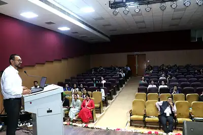 Presenter at podium facing auditorium at PHASECON 2023