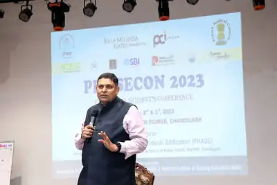 Speaker addressing audience at PHASECON 2023 in front of conference screen