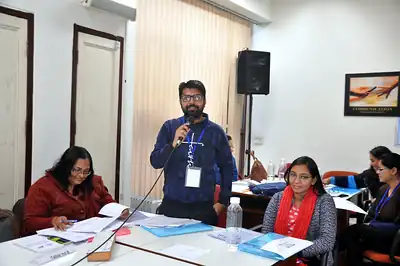 Participant asking question with microphone in scientific writing workshop