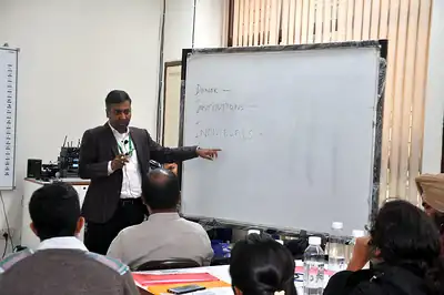 Faculty writing on whiteboard during scientific writing session