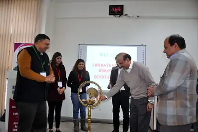 Guests lighting ceremonial lamp at opening of scientific writing workshop